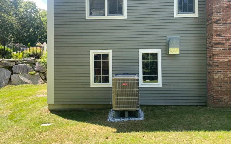 Residential heat pump with heat pump stand.